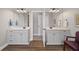 Dual vanities on wood floors featuring a connecting doorway at 7425 Twin Creek Ct, Cumming, GA 30041