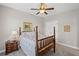 Bedroom with a ceiling fan, double door closet, and a cozy four-poster bed at 7425 Twin Creek Ct, Cumming, GA 30041