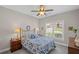 Cozy bedroom featuring a ceiling fan and a large window at 7425 Twin Creek Ct, Cumming, GA 30041