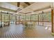 Spacious covered deck with a fan over a picnic table and a view of the pool at 7425 Twin Creek Ct, Cumming, GA 30041