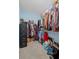 Spacious walk-in closet offering ample storage space with plenty of clothing and filing cabinets at 7425 Twin Creek Ct, Cumming, GA 30041