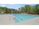 Large community pool with a beach entrance, a waterslide, and a six lane lap-pool at 7425 Twin Creek Ct, Cumming, GA 30041
