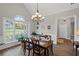 Vaulted ceiling dining room with a large window, natural light, and a wooden table for four at 7425 Twin Creek Ct, Cumming, GA 30041