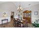 Classic dining room with wainscoting, a vintage chandelier, and seating for four at 7425 Twin Creek Ct, Cumming, GA 30041