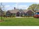 Charming brick home with well-manicured lawn, blue shutters, and a welcoming front entrance at 7425 Twin Creek Ct, Cumming, GA 30041
