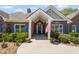 Inviting front entrance with brick facade, blue door, and manicured landscaping at 7425 Twin Creek Ct, Cumming, GA 30041