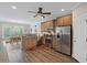 The kitchen has stainless steel appliances, a breakfast bar, and flows into the breakfast nook at 7425 Twin Creek Ct, Cumming, GA 30041