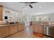 Bright eat-in kitchen featuring wood-look floors, a view into the living room, and stainless steel appliances at 7425 Twin Creek Ct, Cumming, GA 30041