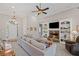Cozy living room features a stone fireplace, built-in shelving and ample natural light at 7425 Twin Creek Ct, Cumming, GA 30041