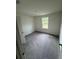 Bright, carpeted bedroom with window offering scenic outdoor views at 87 Sonoma Drive, Dallas, GA 30157
