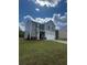 Two-story home with a neatly landscaped yard and driveway on a sunny day at 87 Sonoma Drive, Dallas, GA 30157