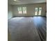 Bright living room featuring plush carpeting and access to a patio at 87 Sonoma Drive, Dallas, GA 30157
