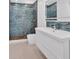 Modern bathroom with blue tile shower and floating vanity at 1075 Peachtree Ne Walk # A421, Atlanta, GA 30309