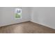 Empty bedroom with hardwood floors and a window view at 1075 Peachtree Ne Walk # A421, Atlanta, GA 30309