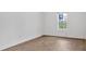 Empty bedroom features hardwood floors and a sunlit window view at 1075 Peachtree Ne Walk # A421, Atlanta, GA 30309