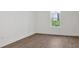 Bedroom features hardwood floors, a window view, and fresh white paint at 1075 Peachtree Ne Walk # A421, Atlanta, GA 30309