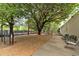 Community dog park under shade trees provides an area for residents to exercise their dogs at 1075 Peachtree Ne Walk # A421, Atlanta, GA 30309