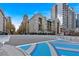 Attractive apartment building with a contemporary design, surrounded by cityscapes under a clear blue sky at 1075 Peachtree Ne Walk # A421, Atlanta, GA 30309