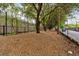 Fenced community green space with mature trees provides an area for relaxing and walking at 1075 Peachtree Ne Walk # A421, Atlanta, GA 30309
