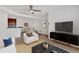 A living room with a ceiling fan, modern furnishings, and an open layout, connecting to a dining area and kitchen at 1075 Peachtree Ne Walk # A421, Atlanta, GA 30309