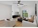 Bright living room features a ceiling fan, modern furniture, and a sliding glass door leading to the outside at 1075 Peachtree Ne Walk # A421, Atlanta, GA 30309