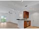 Bright living room and kitchen area features hardwood floors, granite countertops, stainless steel appliances, and a balcony at 1075 Peachtree Ne Walk # A421, Atlanta, GA 30309