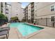 Outdoor pool surrounded by lounge chairs and black metal fencing at 1075 Peachtree Ne Walk # A421, Atlanta, GA 30309