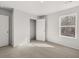 Cozy bedroom featuring neutral carpet, closet, and a window that allows natural light to stream in at 120 Hampton Ter, Dallas, GA 30157