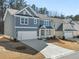 Charming two-story home featuring a wide driveway, inviting covered porch, and a neatly landscaped front yard at 120 Hampton Ter, Dallas, GA 30157