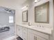 Bright bathroom featuring dual sinks, a modern vanity, and a glass-enclosed shower, connecting to the bedroom at 1263 Harvest Park Ln, Suwanee, GA 30024