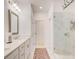 Elegant bathroom featuring a double vanity, a framed mirror, and a glass-enclosed marble tile shower at 1263 Harvest Park Ln, Suwanee, GA 30024
