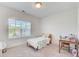 A serene bedroom featuring a window with blinds, small wooden desk, and cozy twin bed at 1263 Harvest Park Ln, Suwanee, GA 30024