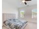 Inviting bedroom featuring neutral tones, a comfortable bed, and two windows that provide natural light at 1263 Harvest Park Ln, Suwanee, GA 30024