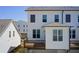 Rear view of townhome showing deck and low maintenance back yard at 1263 Harvest Park Ln, Suwanee, GA 30024