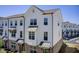 New townhome with white siding, brick accents, black awnings, and large windows at 1263 Harvest Park Ln, Suwanee, GA 30024