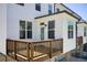 Exterior view of a home featuring a private deck, white siding, and a well-kept yard at 1263 Harvest Park Ln, Suwanee, GA 30024