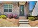 Charming home exterior with brick facade, inviting front door, and manicured landscaping at 1263 Harvest Park Ln, Suwanee, GA 30024