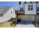 Townhome garage and elevated deck with a well maintained lawn at 1263 Harvest Park Ln, Suwanee, GA 30024