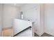 Well-lit hallway with hardwood floors, featuring a staircase and closet space at 1263 Harvest Park Ln, Suwanee, GA 30024
