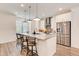 Modern kitchen with a large island, stainless steel appliances, and stylish pendant lighting at 1263 Harvest Park Ln, Suwanee, GA 30024