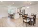 Modern kitchen with stainless steel appliances, a center island, and an adjacent dining area at 1263 Harvest Park Ln, Suwanee, GA 30024
