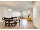 Open-concept living and dining area features hardwood floors, modern lighting, and a cozy fireplace at 1263 Harvest Park Ln, Suwanee, GA 30024