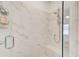 Elegant shower with marble tile surround, glass door, and a built-in bench, creating a spa-like experience at 1263 Harvest Park Ln, Suwanee, GA 30024