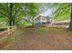 View of backyard featuring trees, lawn, and new wooden fence at 298 Birch St, Atlanta, GA 30354