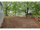 Large backyard featuring trees and new wooden fence at 298 Birch St, Atlanta, GA 30354