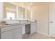 Bright bathroom features dual vessel sinks, granite countertops and modern, lighted mirrors creating an elegant spa-like feel at 208 Crabapple St, Mcdonough, GA 30253