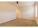 Neutral bedroom featuring carpet, a ceiling fan, and a window providing natural light at 208 Crabapple St, Mcdonough, GA 30253