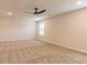 Large, carpeted bedroom with a modern ceiling fan and natural light creates a comfortable and airy atmosphere at 208 Crabapple St, Mcdonough, GA 30253