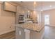 Modern kitchen featuring stainless steel appliances, granite countertops, and stylish pendant lighting at 208 Crabapple St, Mcdonough, GA 30253