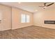 Open-concept living room with ceiling fan, fireplace, and wood-look flooring at 208 Crabapple St, Mcdonough, GA 30253